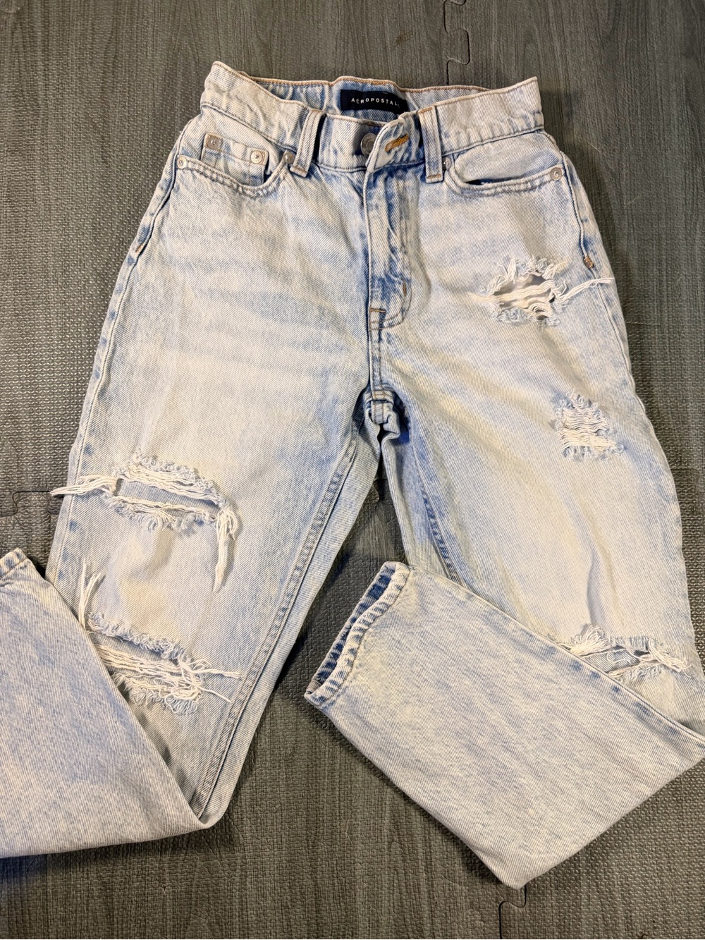 Aéropostale women’s Mom Jeans in a light acid-wash blue denim with heavy distres